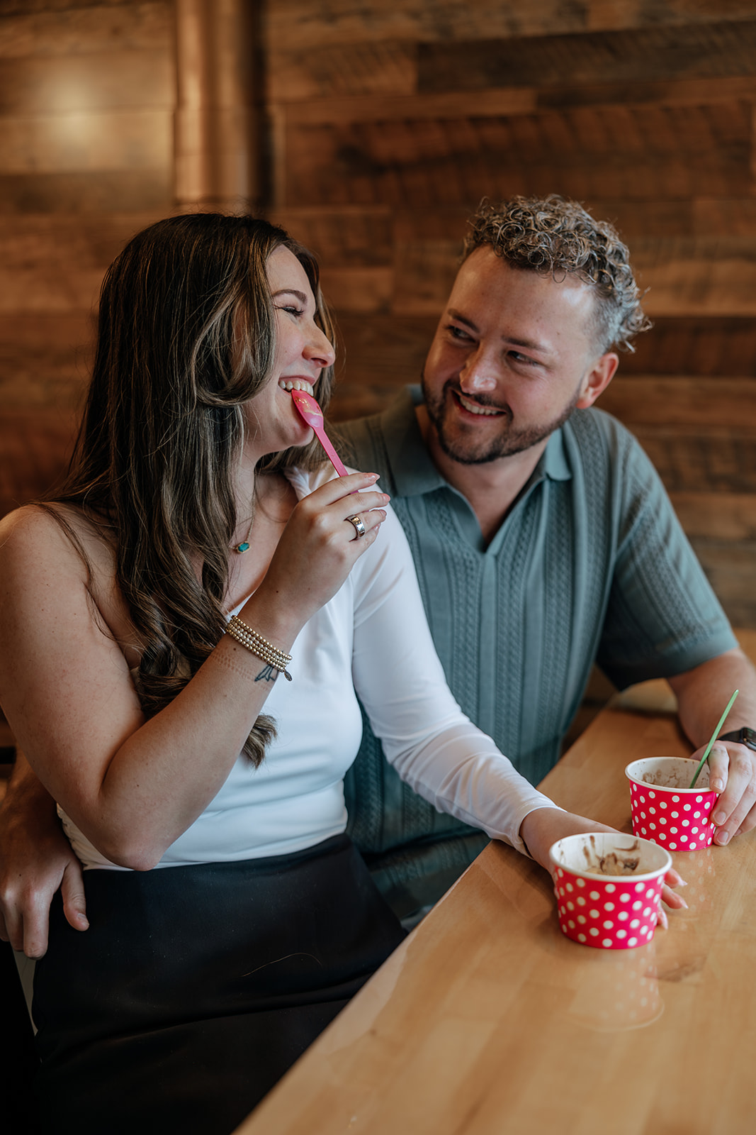 beautiful couple have a fun date at TCBY during their engagement session, sharing fro-yo and laughs