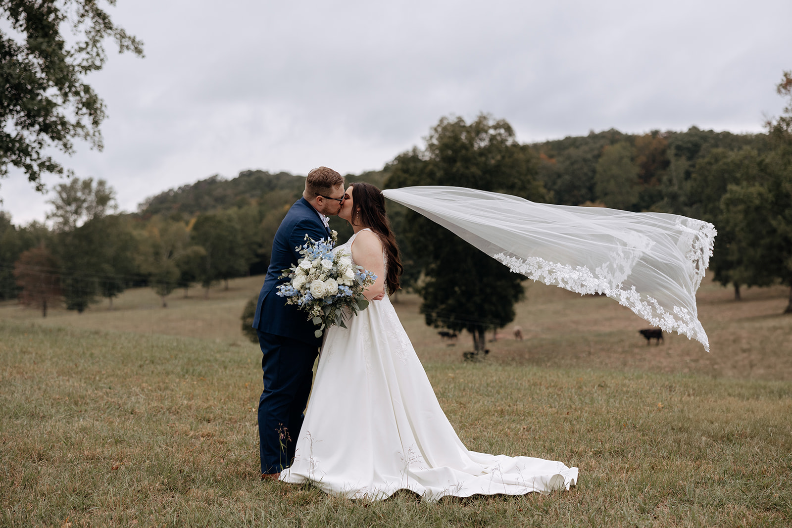 bride and groom share a kiss outside after their forest wedding venue at In The Woods