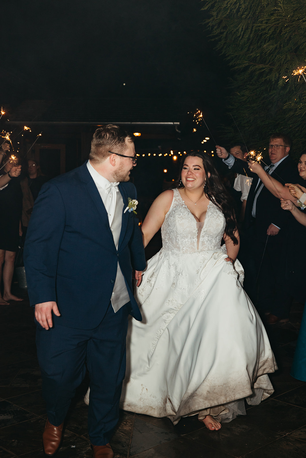 bride and groom exit through sparklers from their forest wedding venue at In The Woods