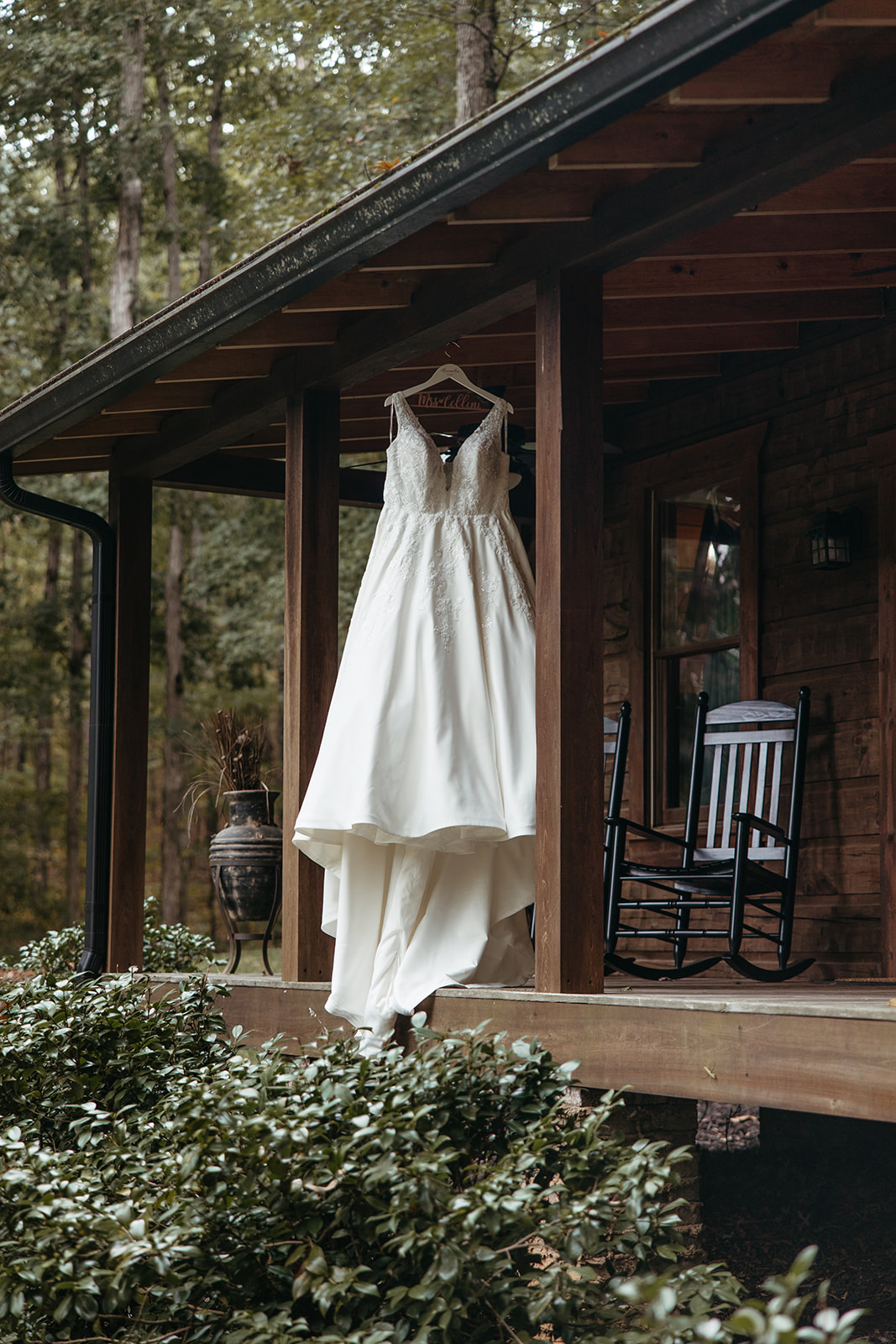 brides dress hangs on the corner of the wedding venue 