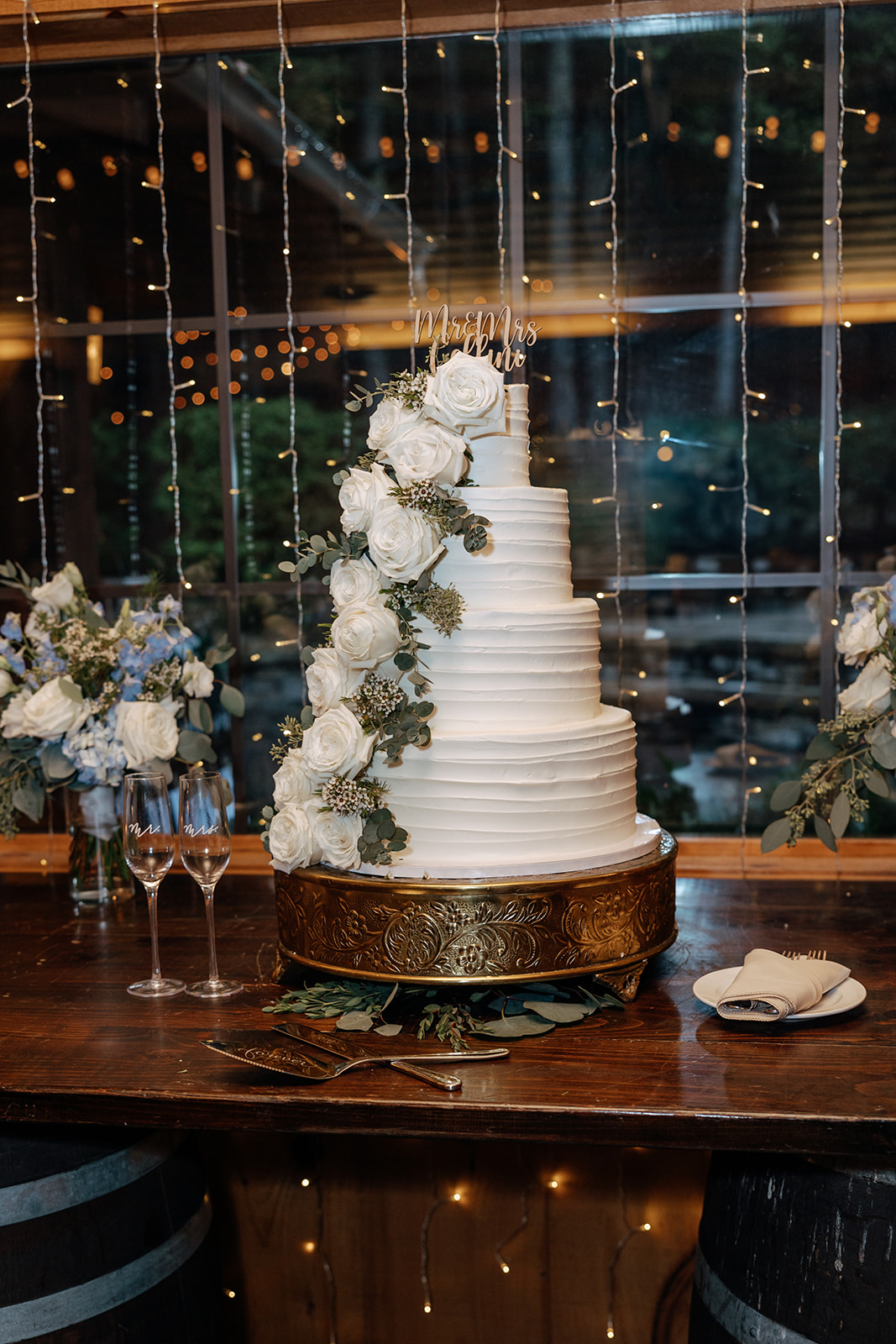 beautiful traditional white 4 tier wedding cake with white flower decor