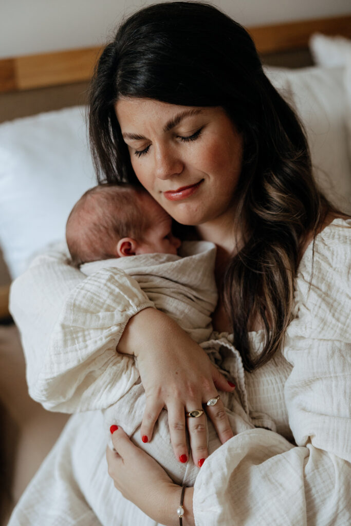 mother hugs newborn baby