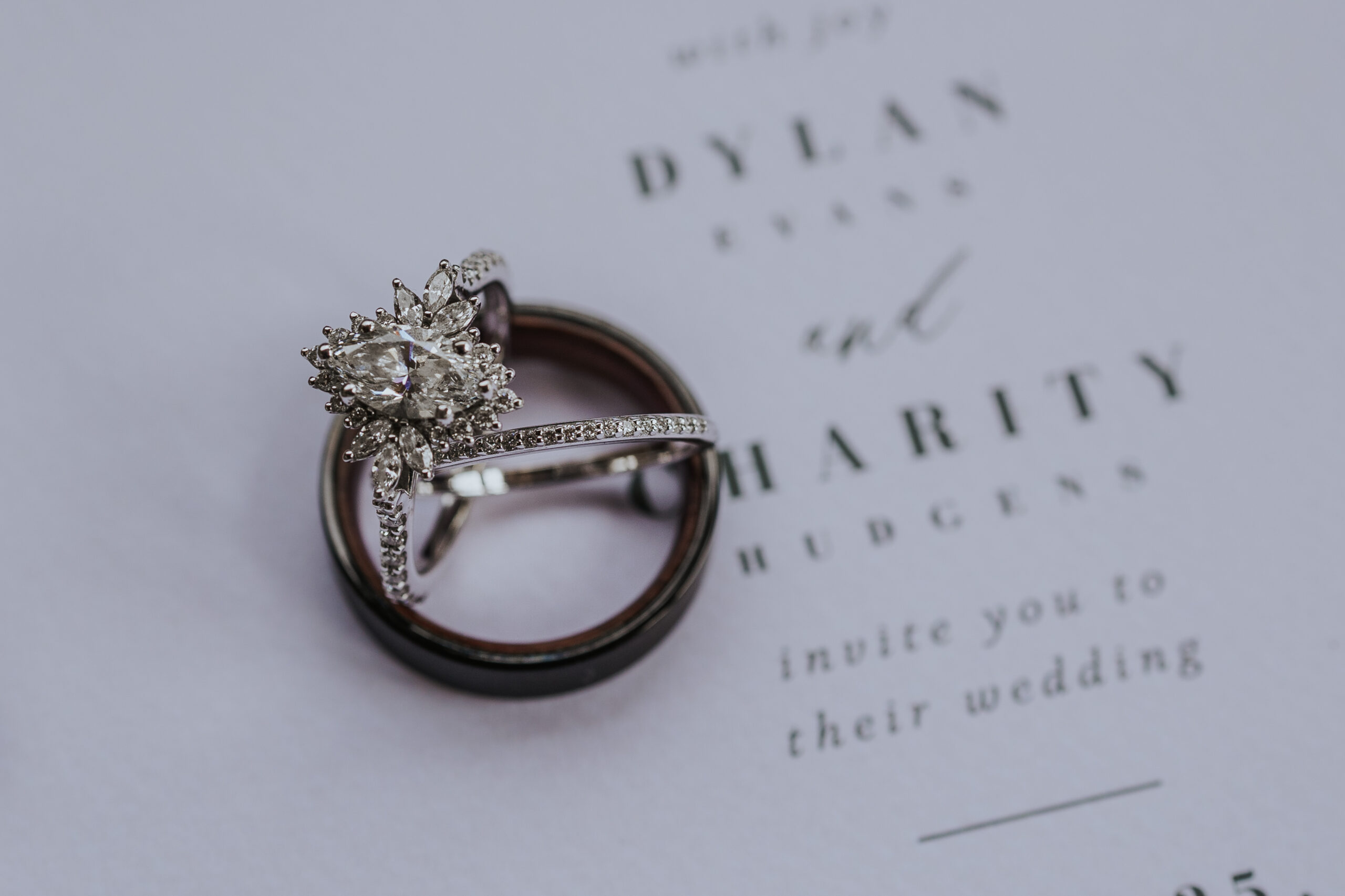 wedding rings stacking on a wedding invitation