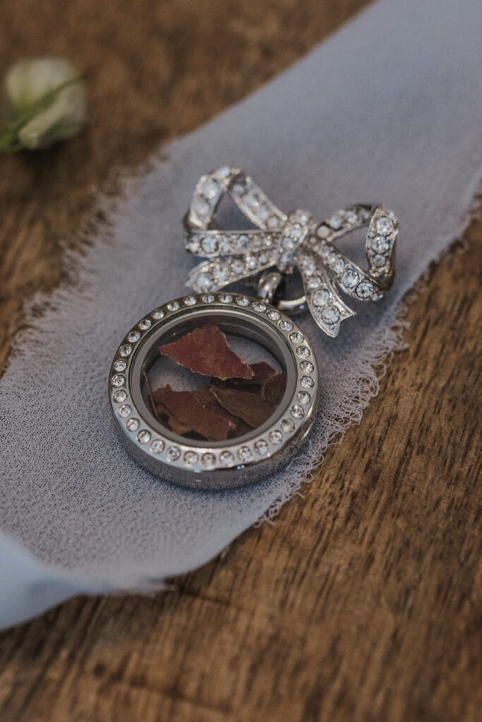 brides bouquet charm laying on a table