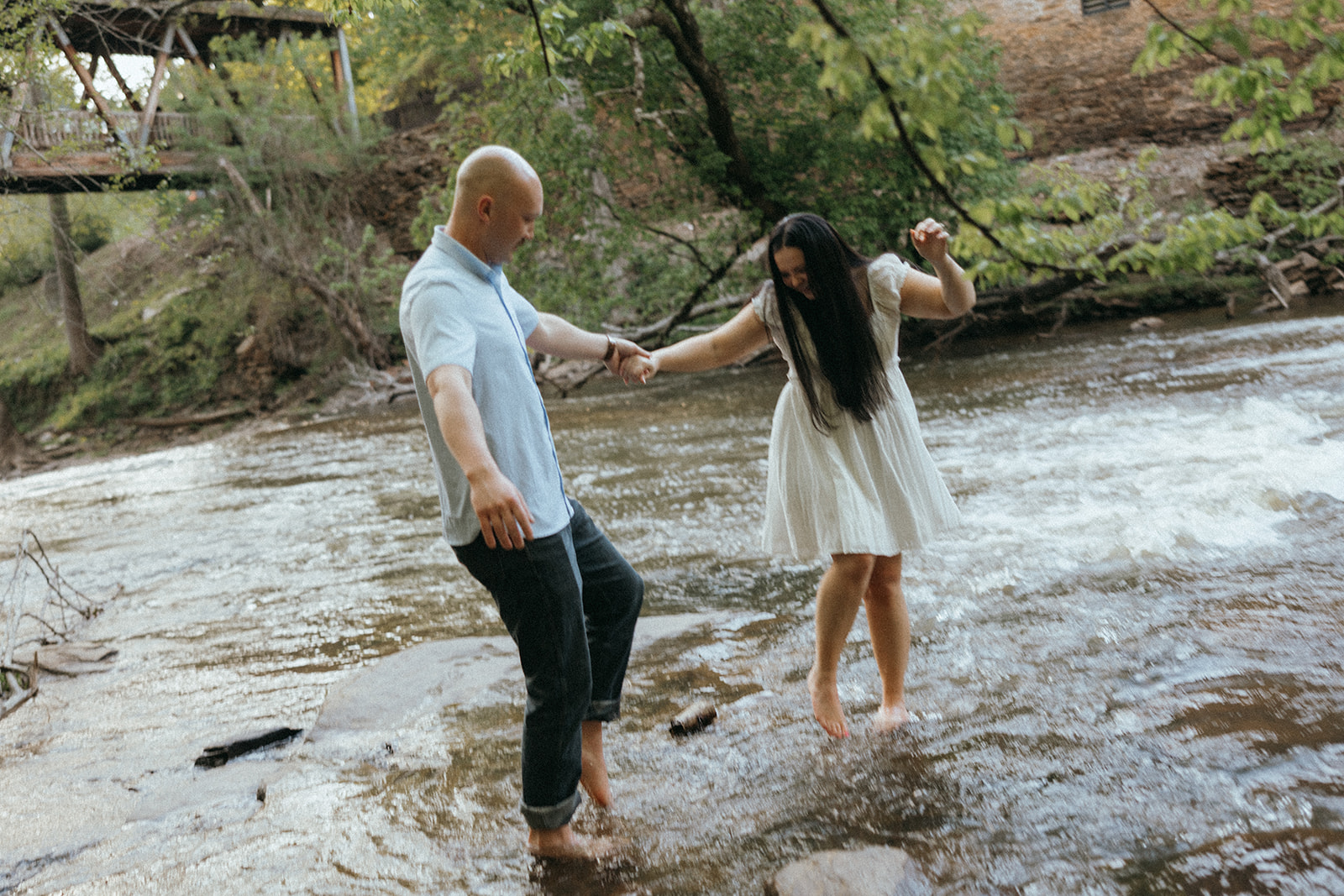 stunning couple dance together in the creek during destination engagement session