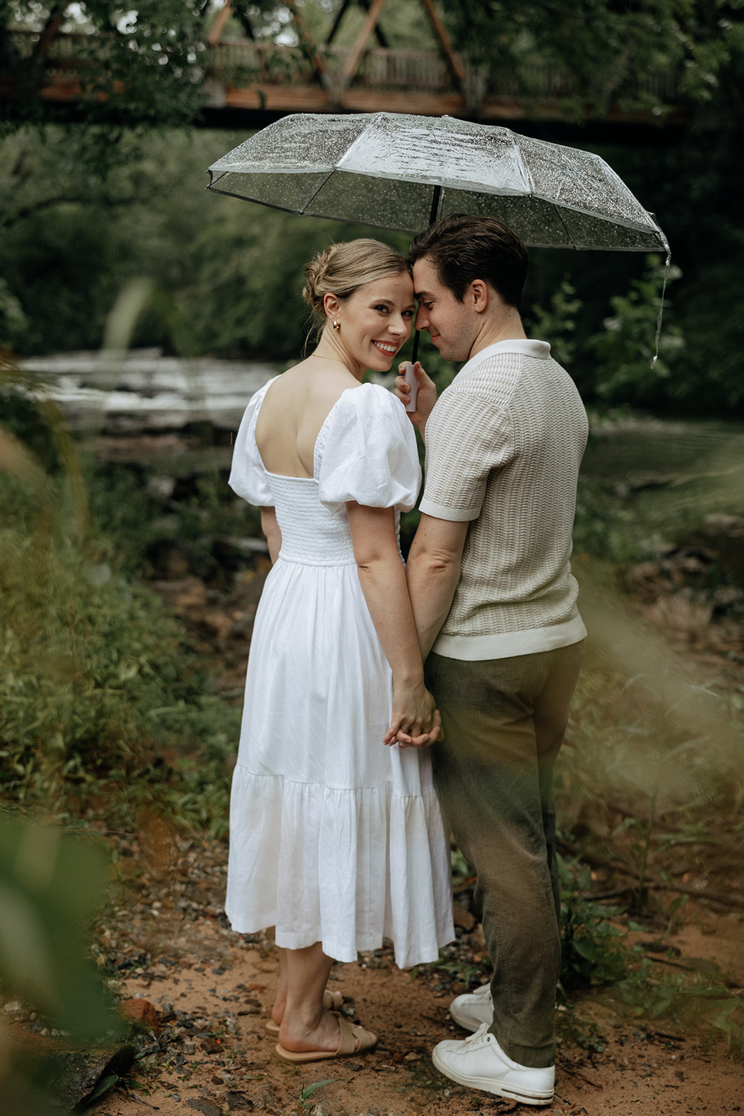 couple at engagement session on a rainy day