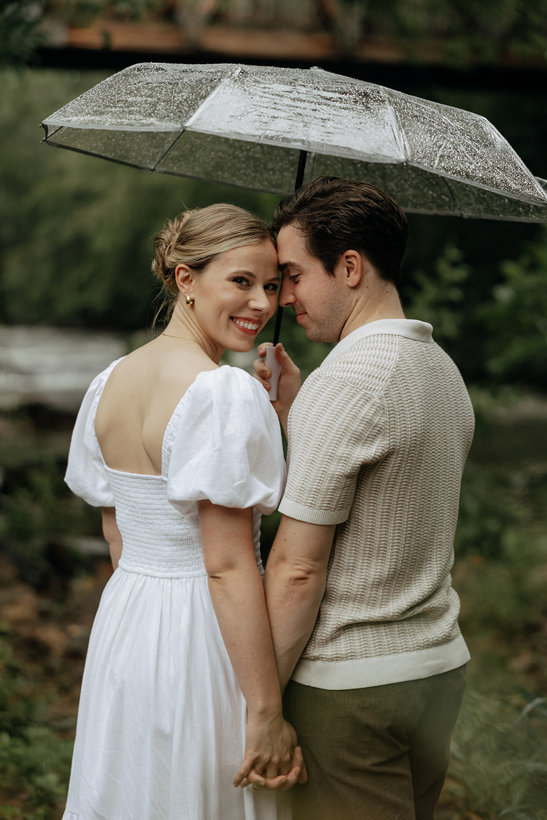 couple at engagement session on a rainy day