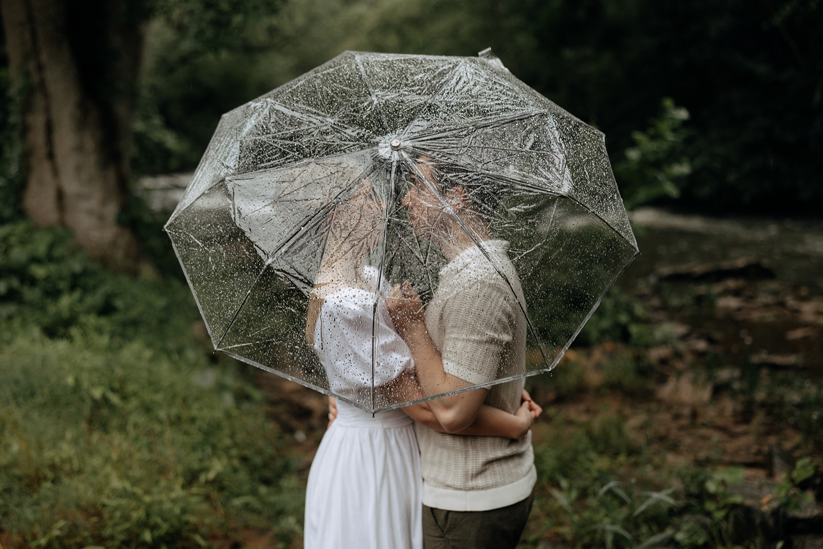couple at engagement session on a rainy day