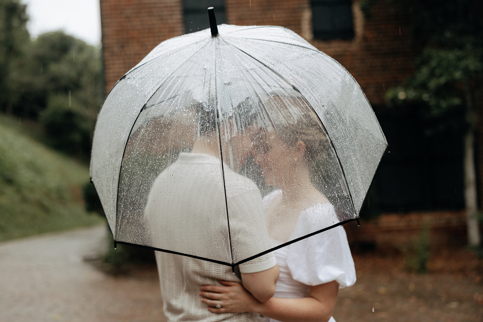couple at engagement session on a rainy day