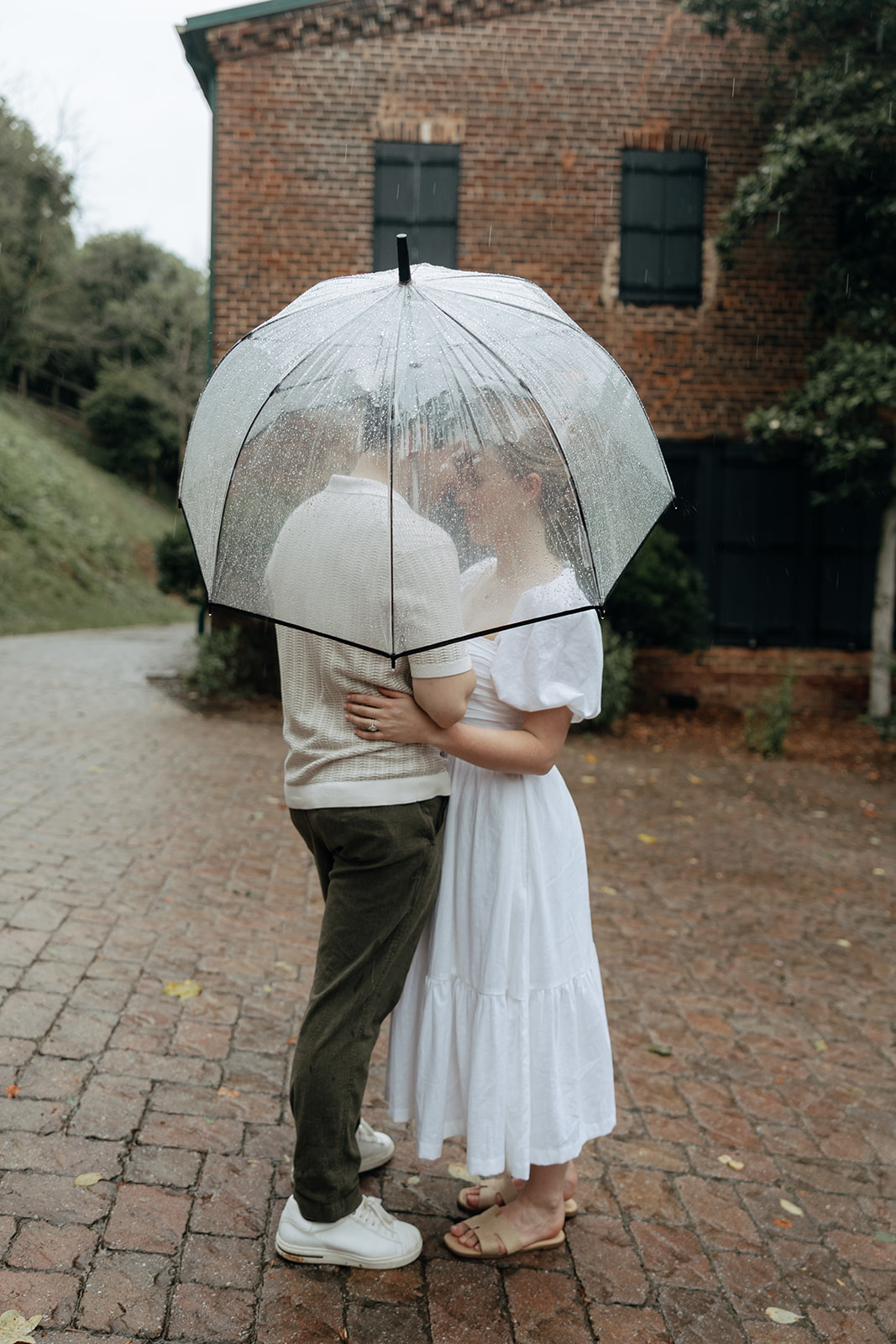 couple at engagement session on a rainy day
