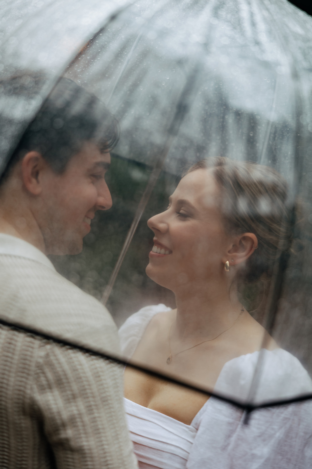 couple at engagement session on a rainy day
