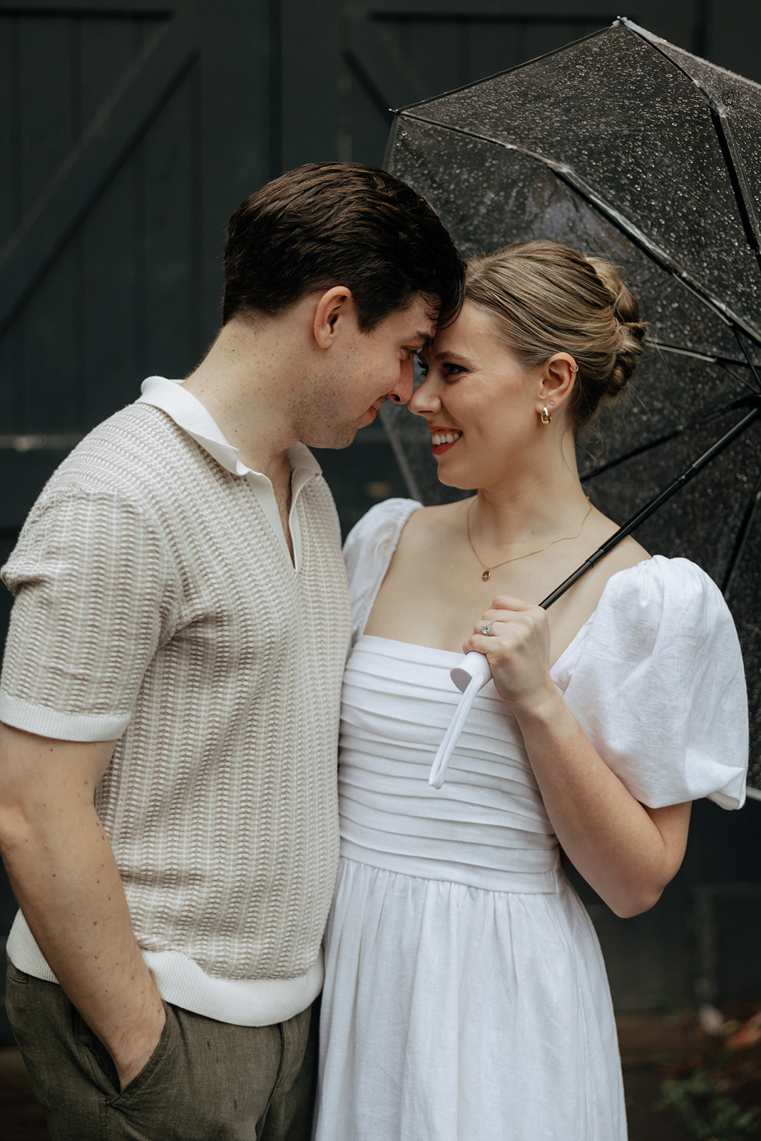 couple at engagement session on a rainy day