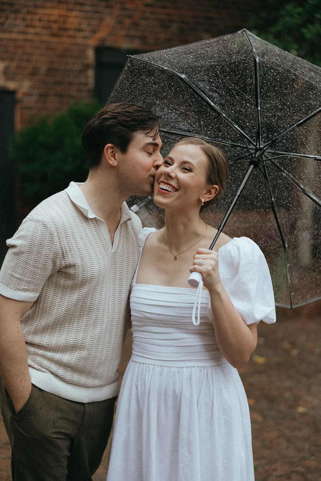 couple at engagement session on a rainy day