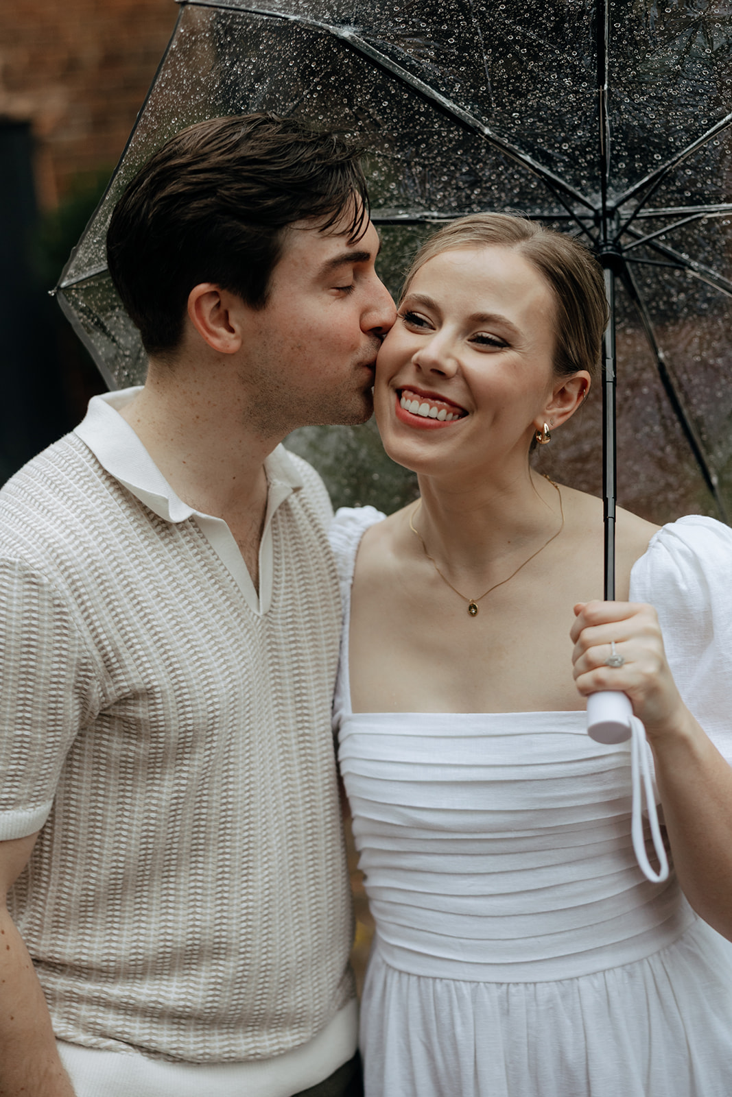 couple at engagement session on a rainy day