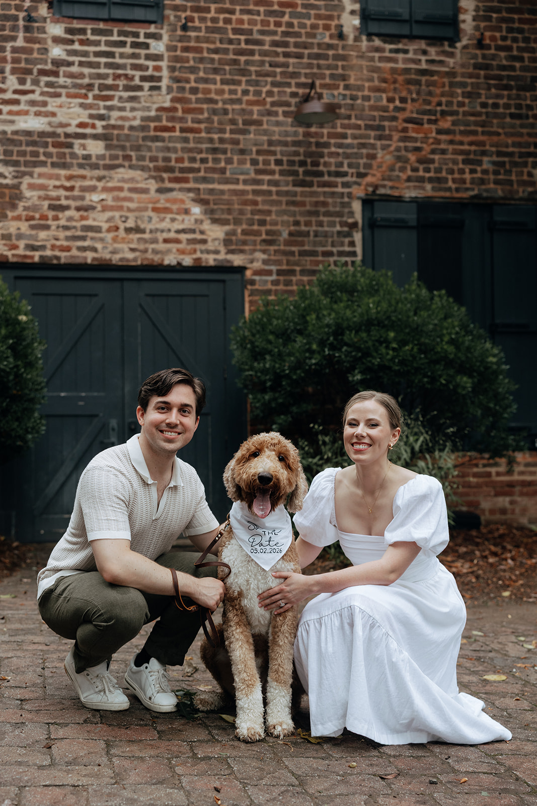 beautiful couple pose with their dog during their creative family photoshoot