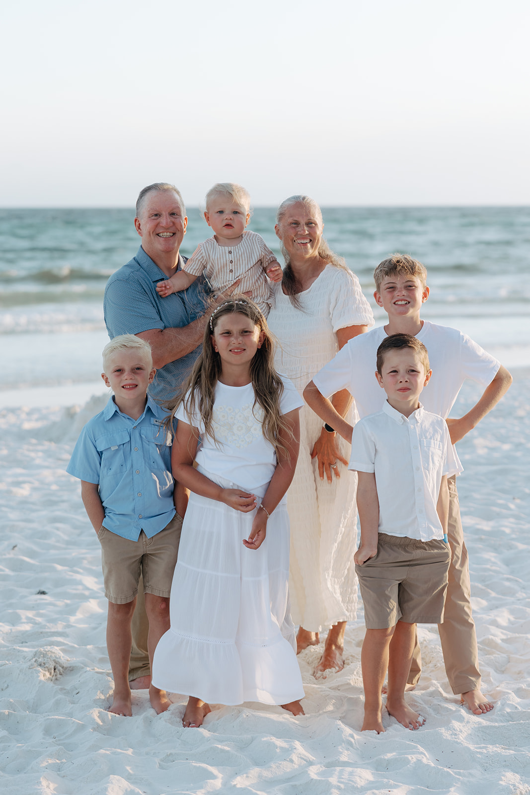 beautiful family pose together on a beach during their family vacation