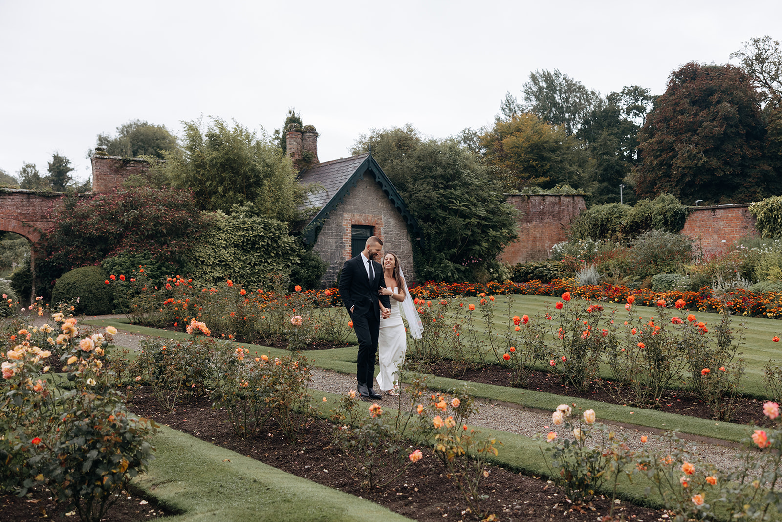 stunning couple pose for photos on the beautiful Dromoland castle grounds