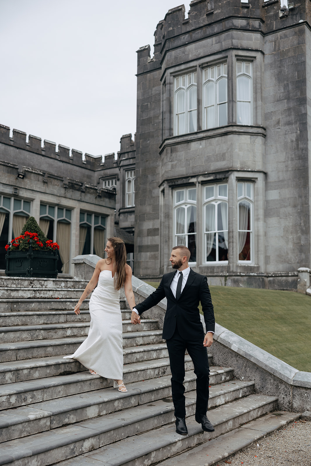 stunning couple walk down the Dromoland castle stairs