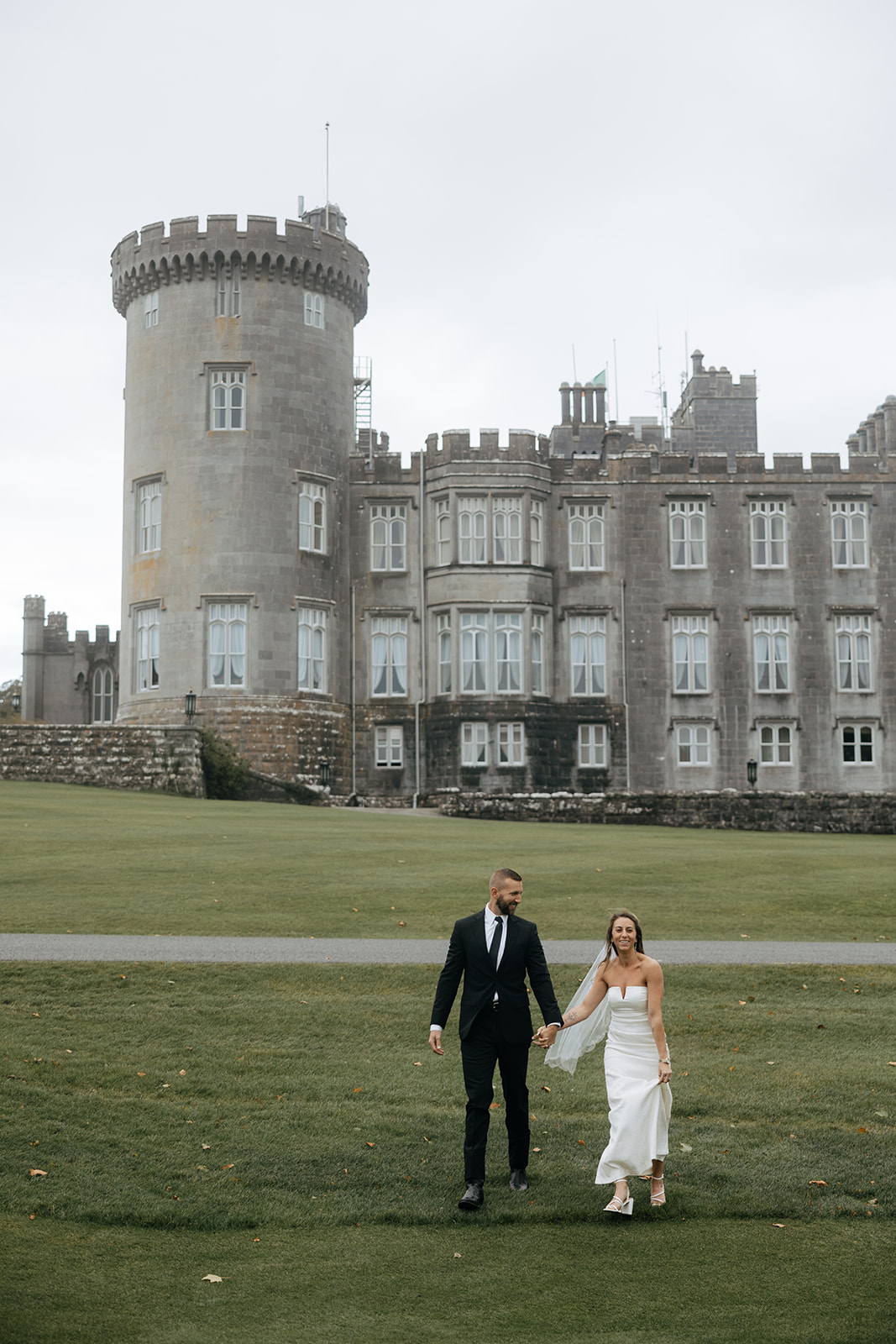stunning couple walk Dromoland castle grounds