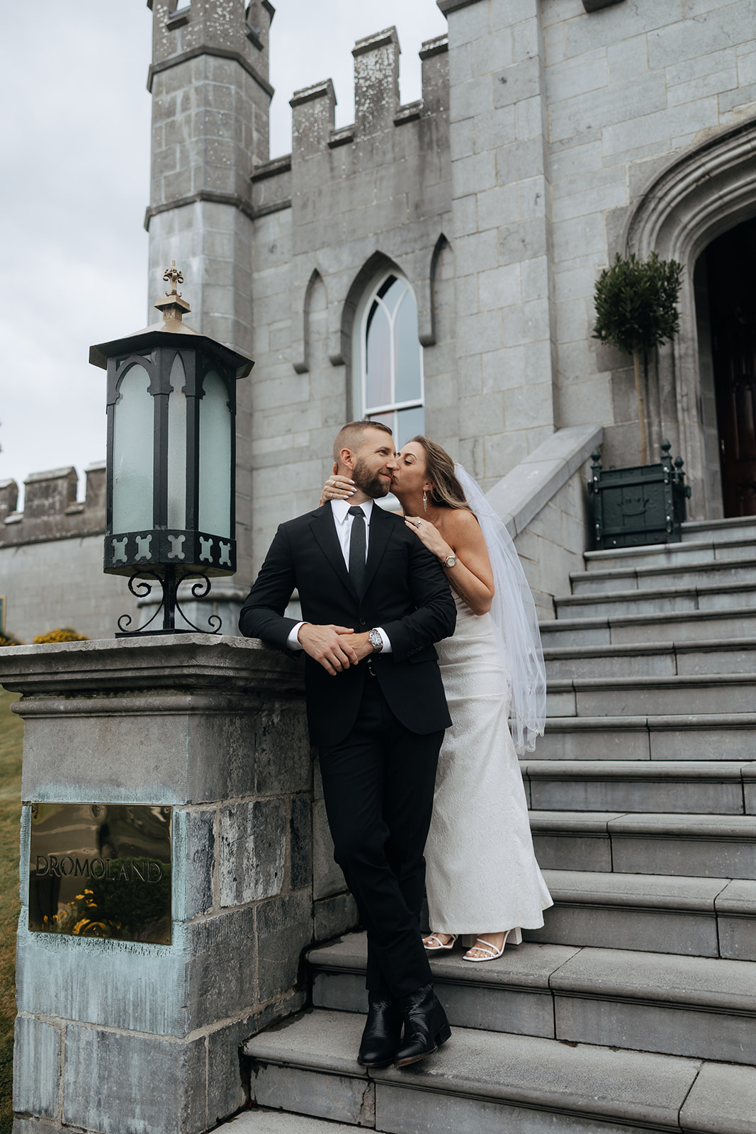 Beautiful couple pose on the castle steps during their stunning Ireland vow renewal
