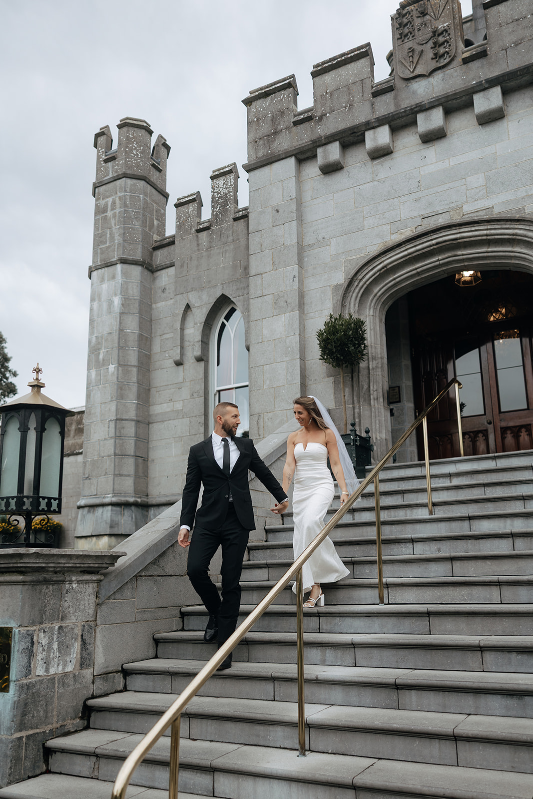 Beautiful couple pose on the castle steps during their stunning Ireland vow renewal