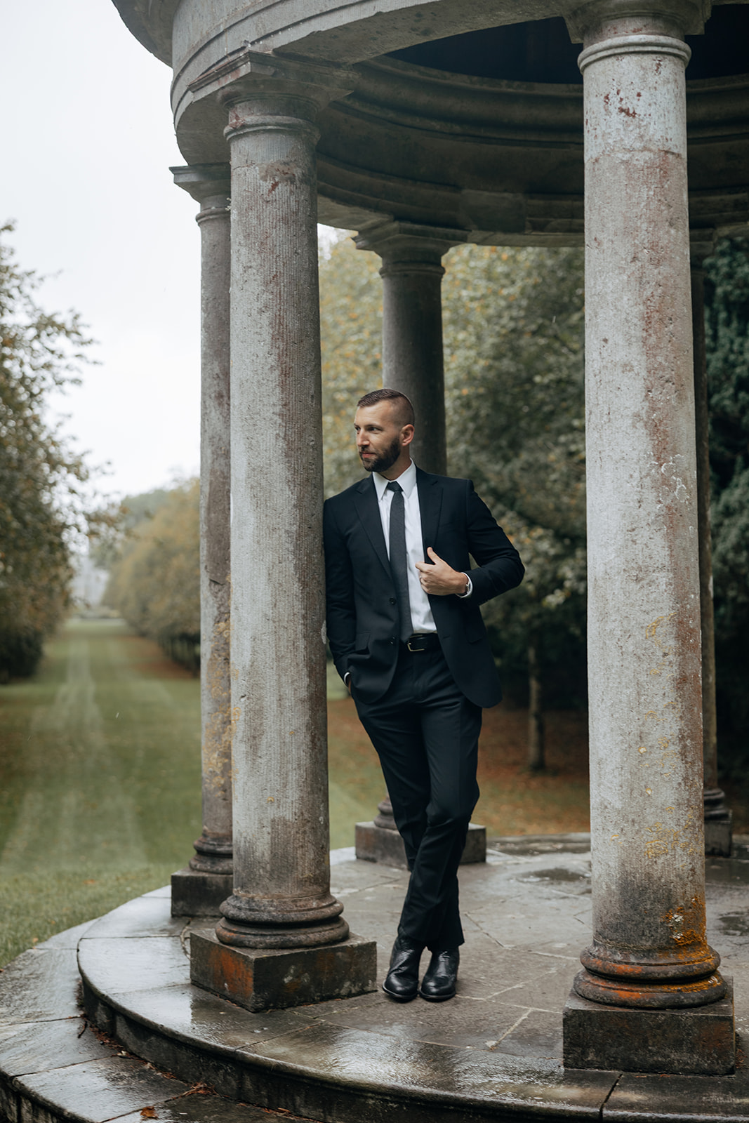 man poses for a photo under the gazebo