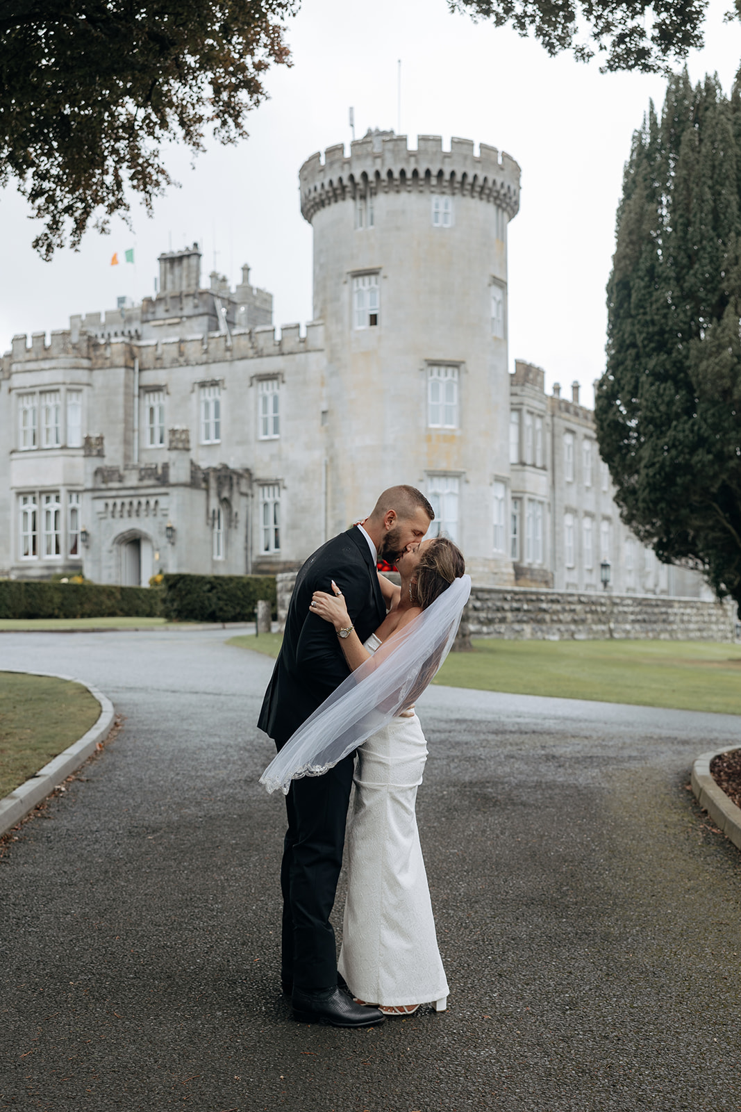 couple share a kiss outside Dromoland castle