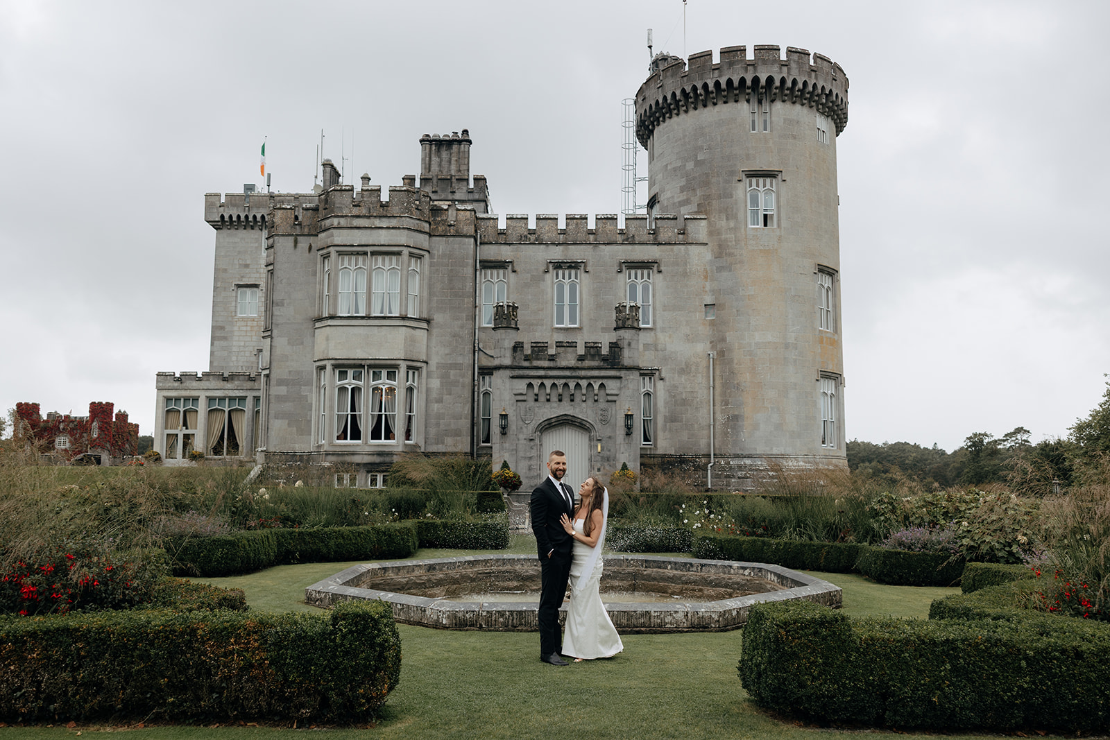 stunning couple walk Dromoland castle grounds during their Ireland vow renewal