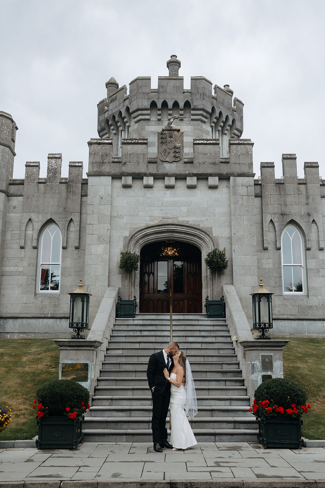 Beautiful couple pose on the castle steps during their stunning Ireland vow renewal