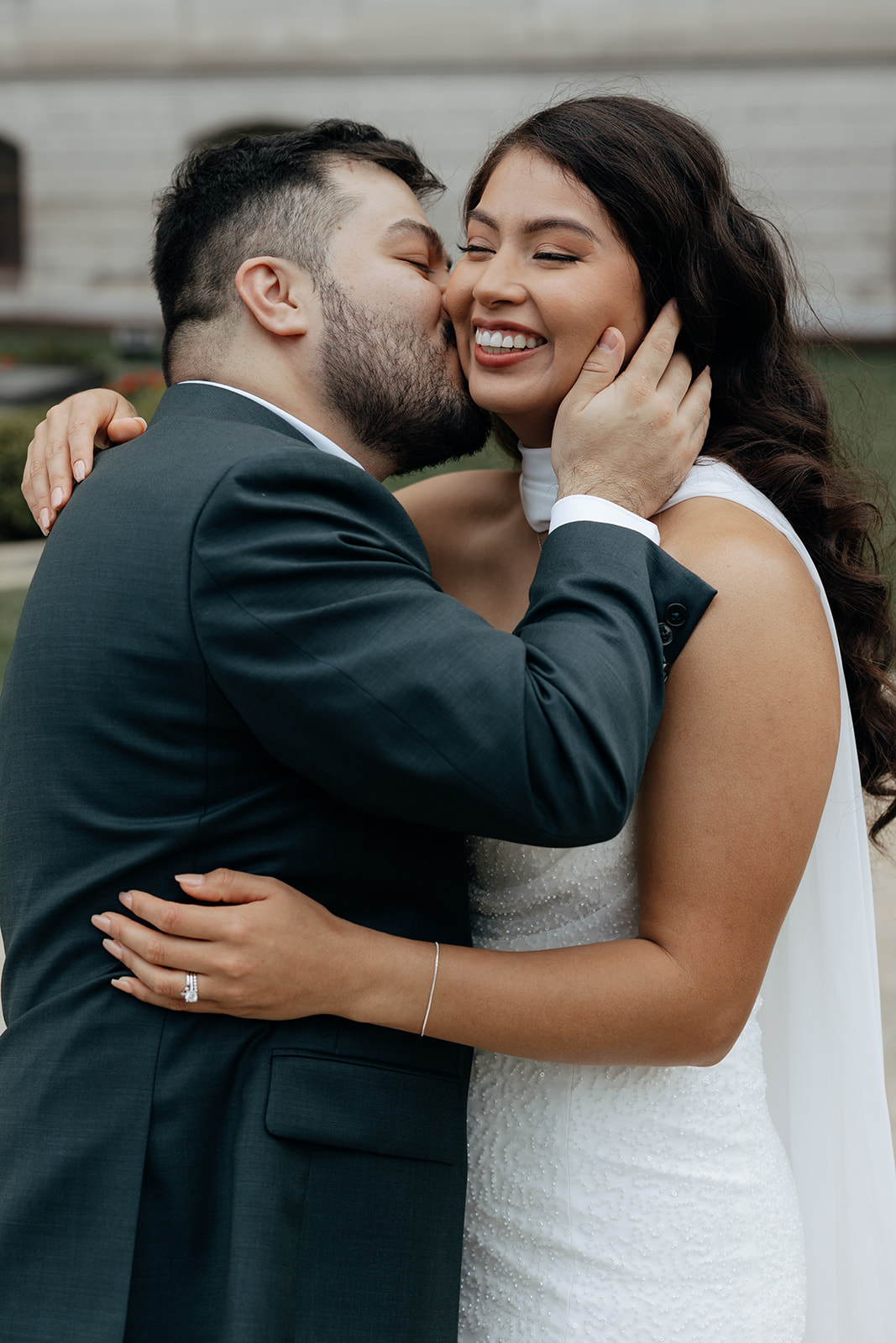 stunning bride and groom share a kiss outside during their Georgia state capitol elopement