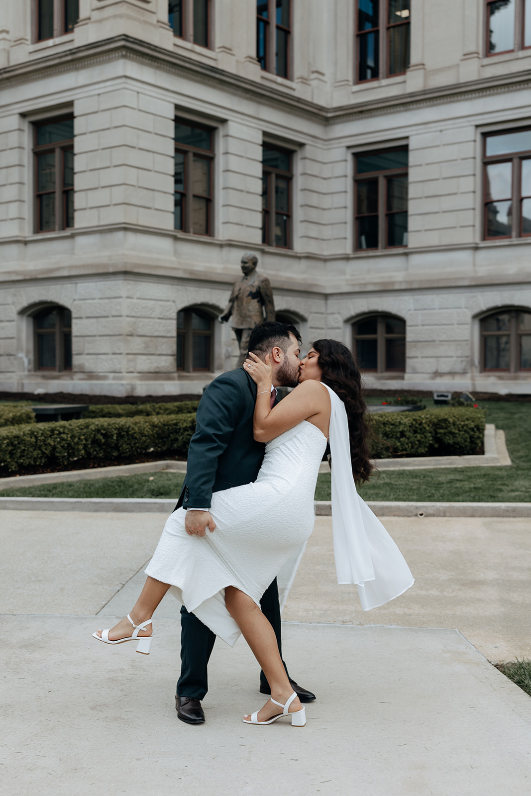 stunning bride and groom share a kiss outside during their Georgia state capitol elopement
