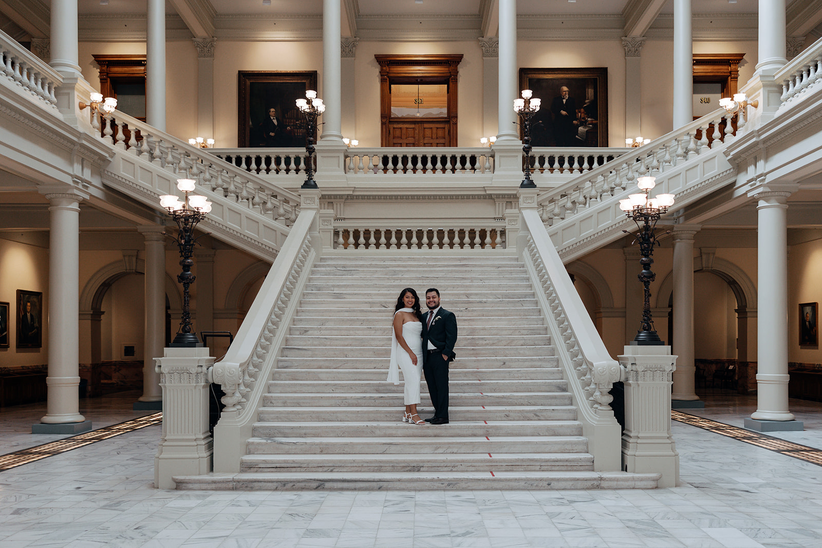 stunning bride and groom pose on the Georgia state capitol steps during their Georgia state capitol elopement