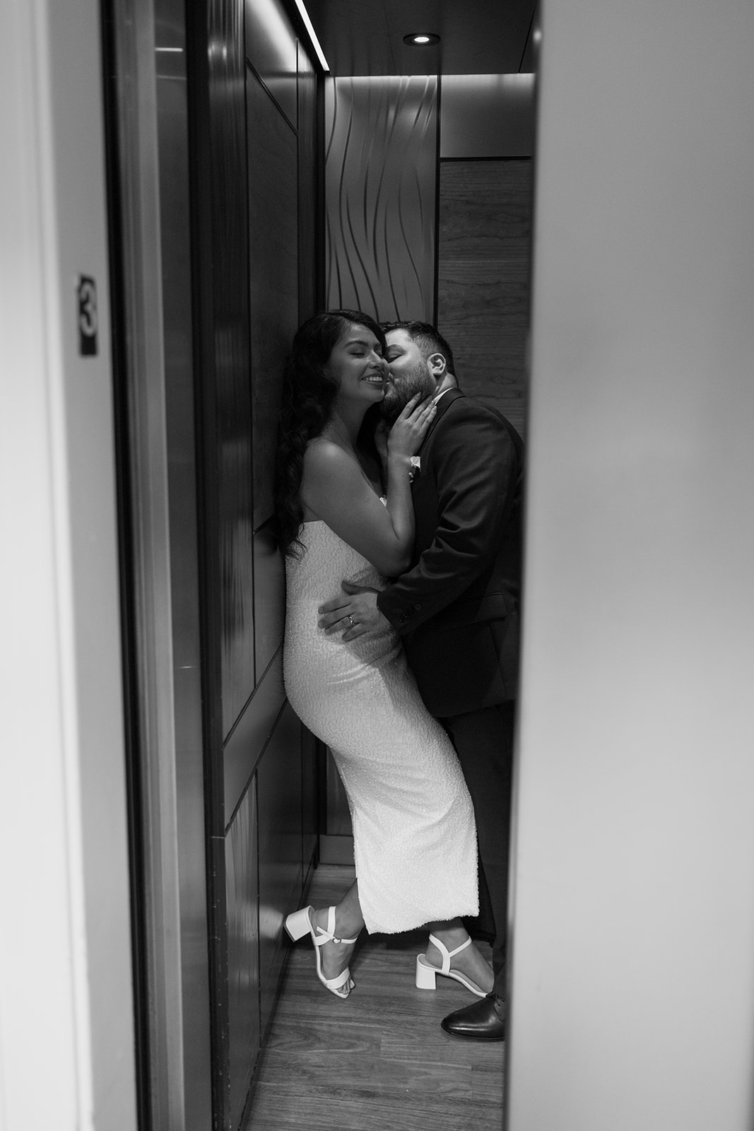 stunning bride and groom share an intimate moment in the elevator together
