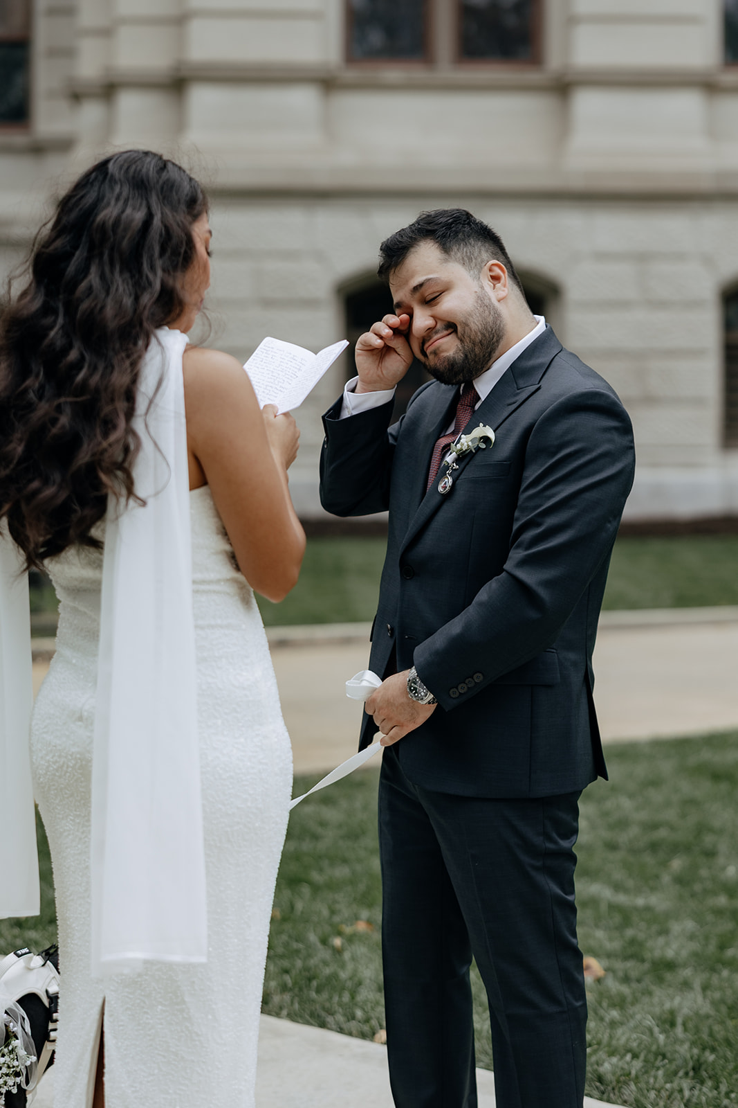 emotional moment shared between bride and groom as they read their wedding vows