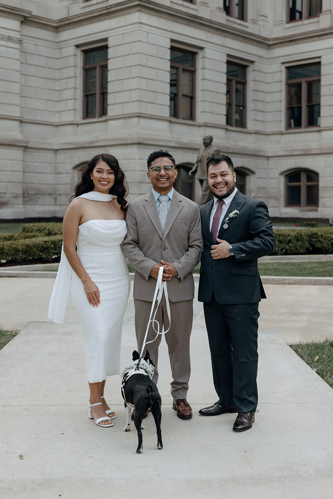 bride and groom pose with their officiant and pupper after a Georgia State Capitol Elopement