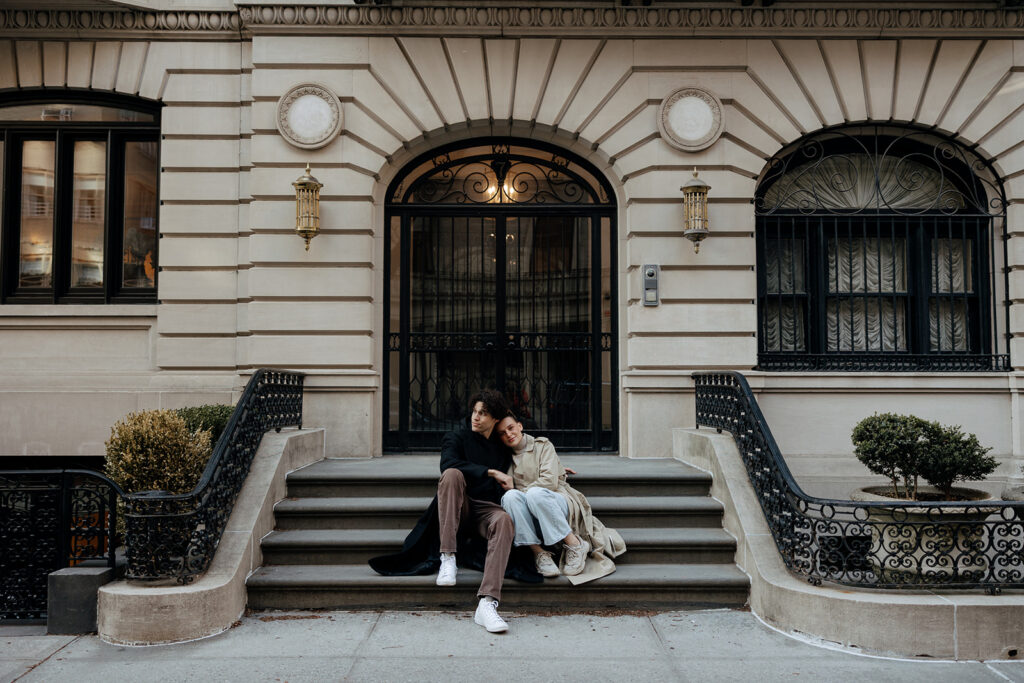 couple snuggle on the stairs a great example of what is an engagement session! You get to decide