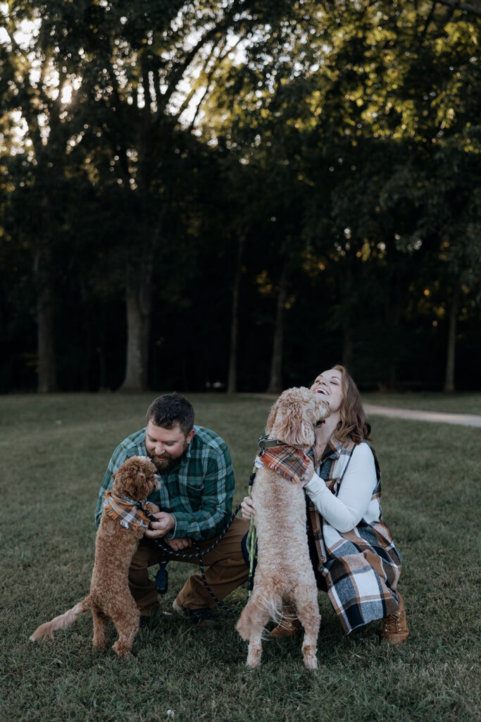 couple pose together with their 2 dogs during their traditional engagement session 