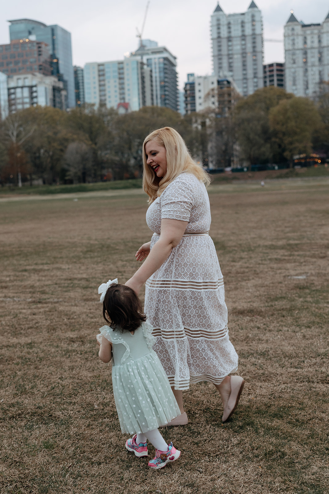 mother and daughter play in the Atlanta park together during her motherhood pictures  