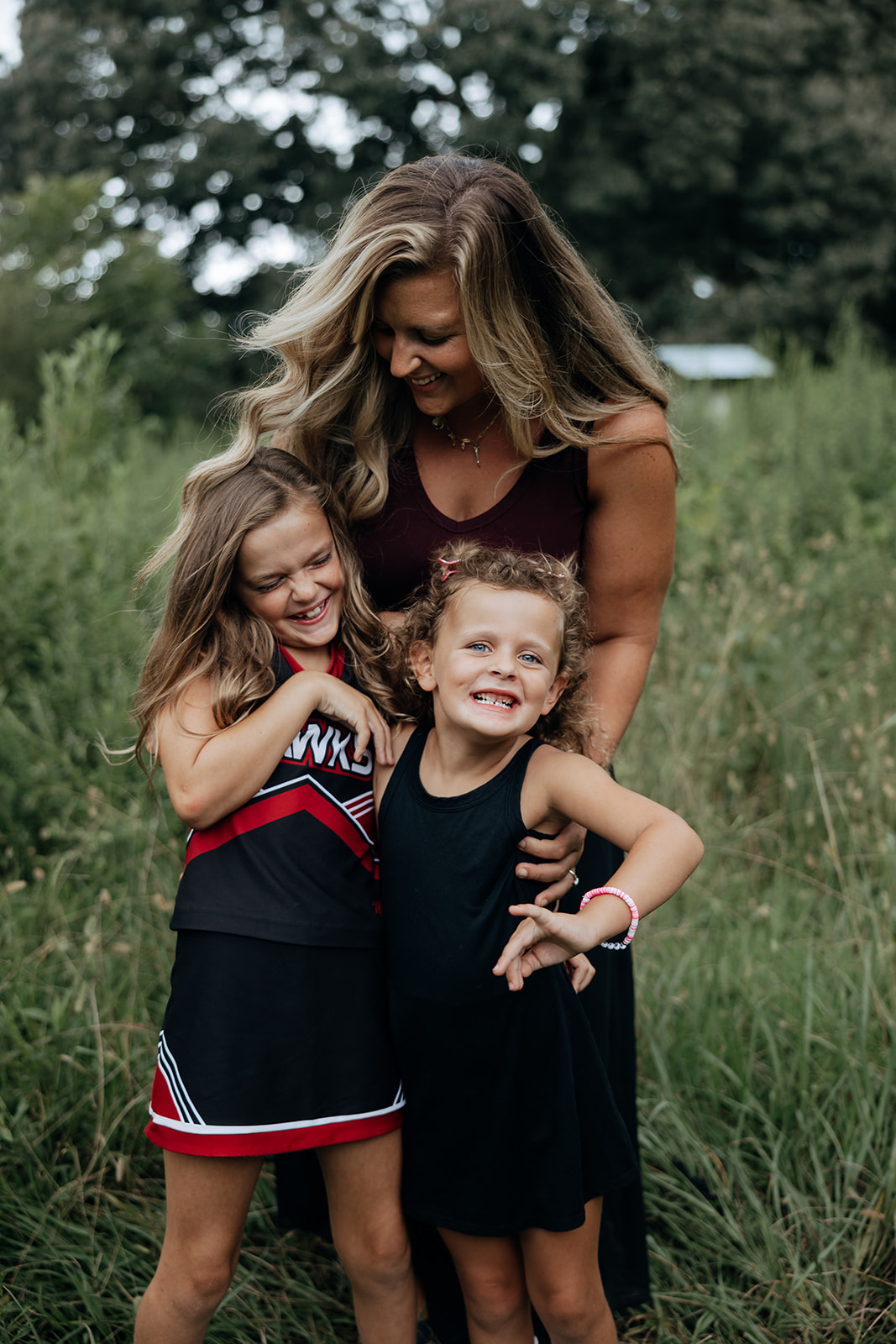 mom poses with her family during their outdoor Georgia motherhood pictures