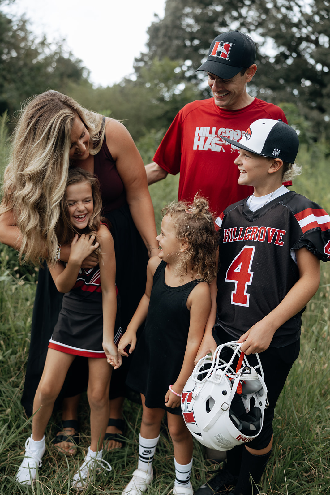 mom poses with her family during their outdoor Georgia motherhood pictures
