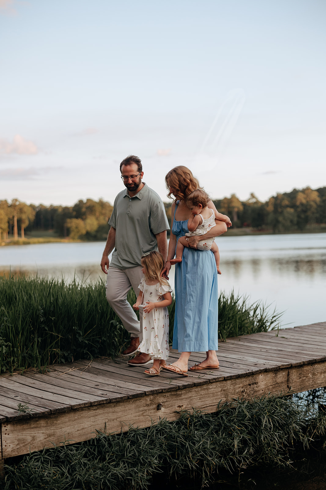 family walk on the dock together during the mother pictures with Rachel Boyd Photography