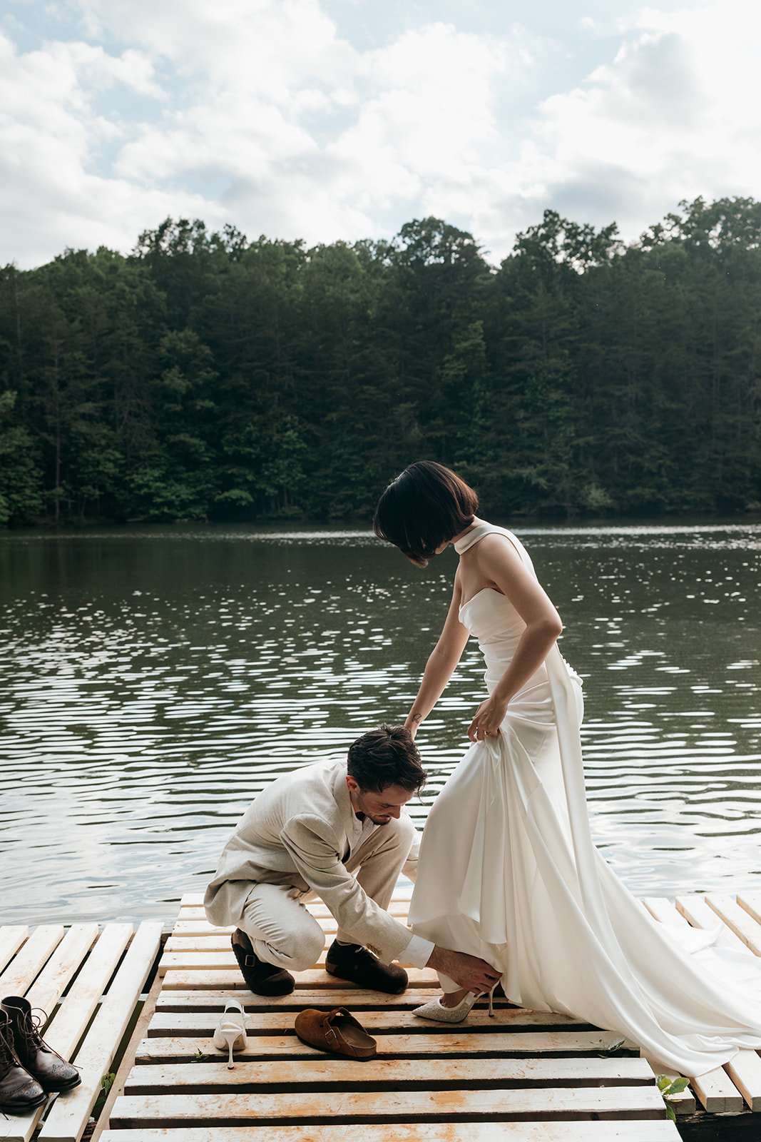 bride finalizes her prep for the Georgia elopement day with a little help from her soon to be husband