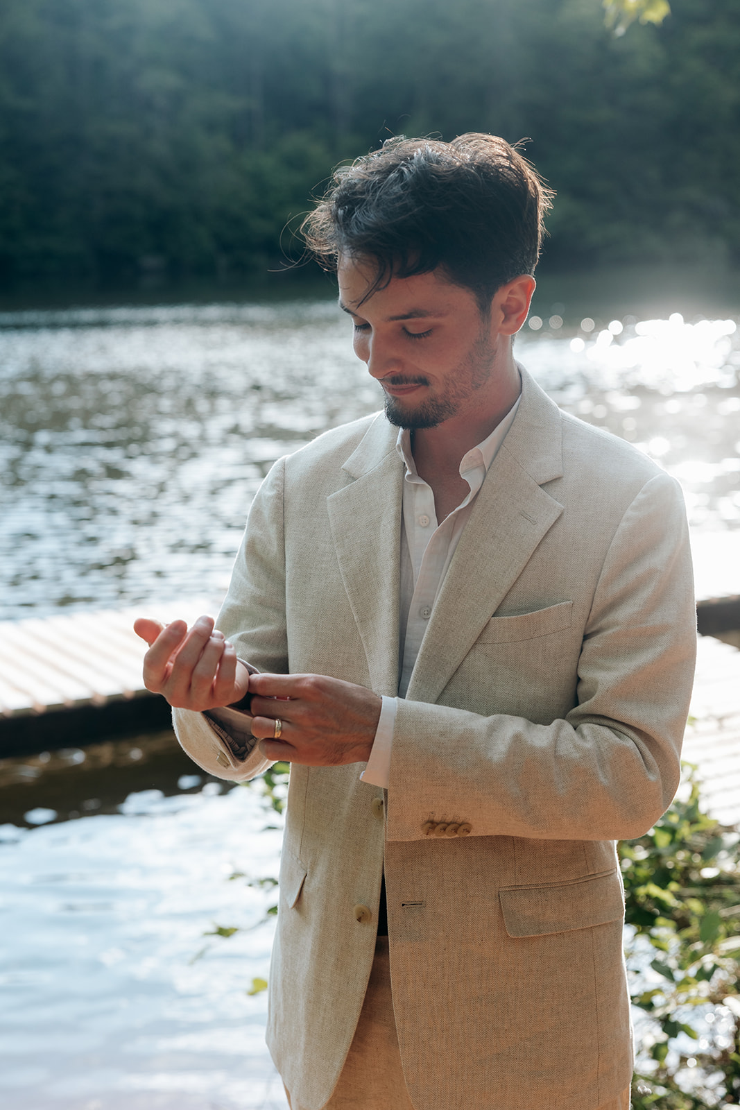 groom finishes his prep for the dock elopement ceremony